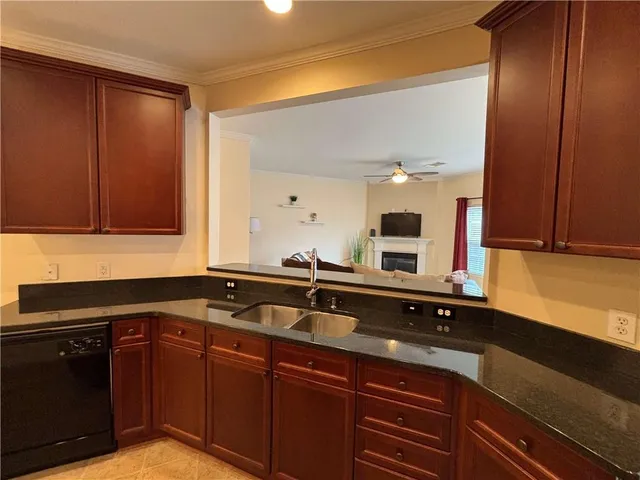 a kitchen with granite countertop a sink and cabinets