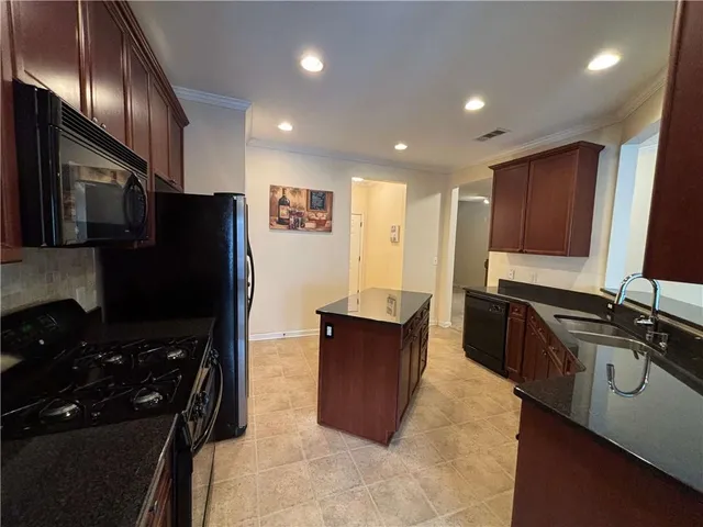 a kitchen with a refrigerator and a sink
