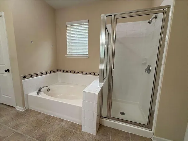 a white bath tub sitting next to a shower