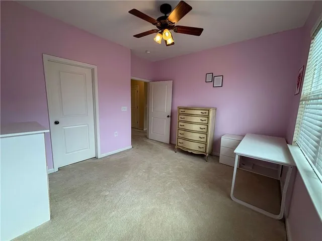 a view of room with window and a ceiling fan