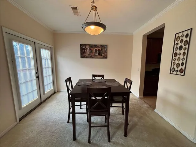 a view of a dining room with furniture and chandelier