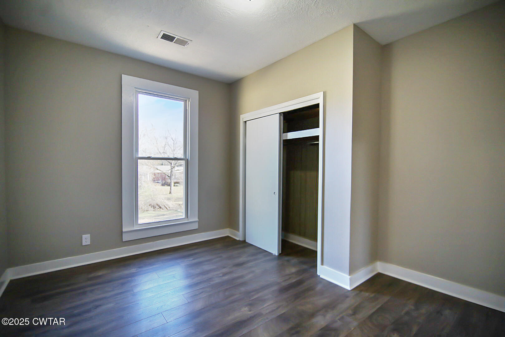 2354 Beech Bluff Road Jackson, TN 38301 - Photo 13 of 18 an empty room with wooden floor closet and windows