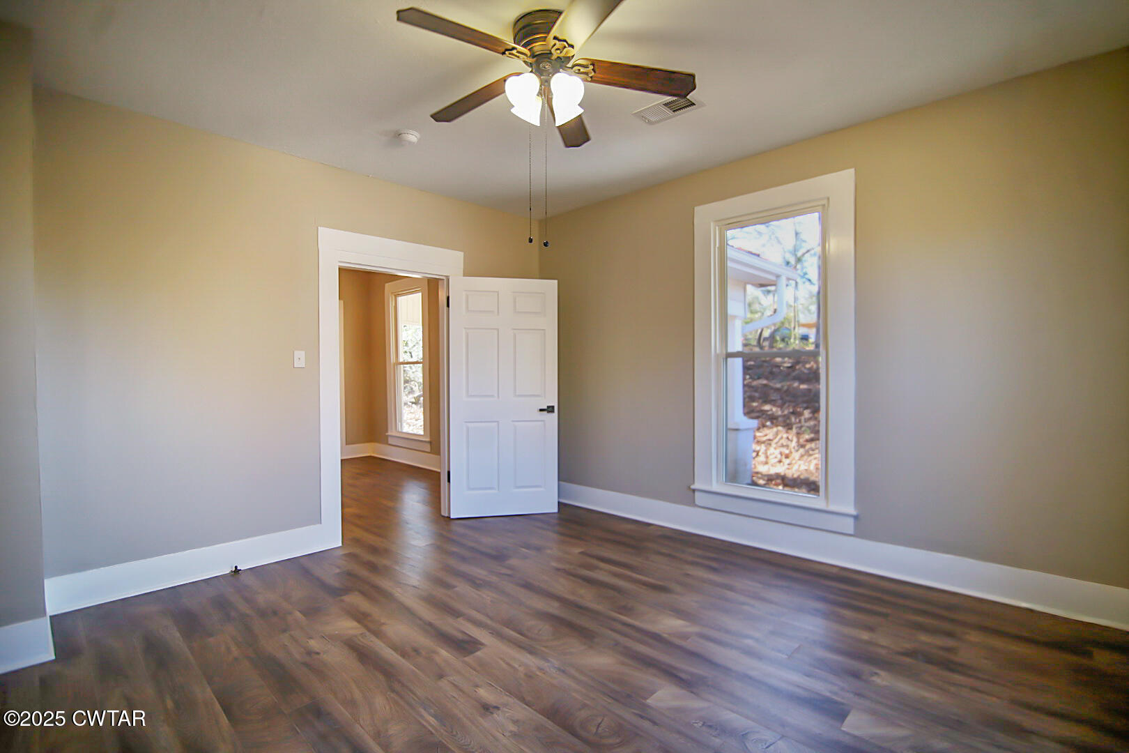 2354 Beech Bluff Road Jackson, TN 38301 - Photo 14 of 18 a view of an empty room with window and wooden floor