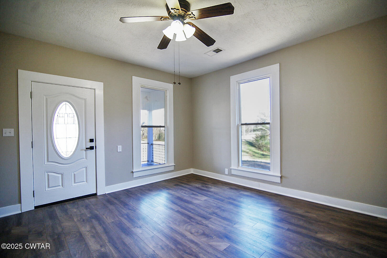 2354 Beech Bluff Road Jackson, TN 38301 - Photo 2 of 18 an empty room with wooden floor chandelier fan and windows