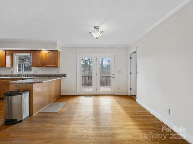 a view of kitchen with granite countertop window and a sink