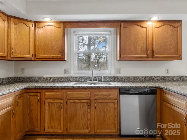 a kitchen with granite countertop cabinets and window