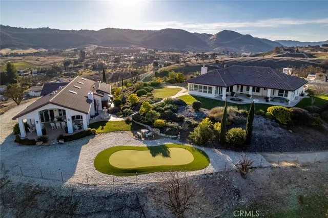 an aerial view of a house with a swimming pool