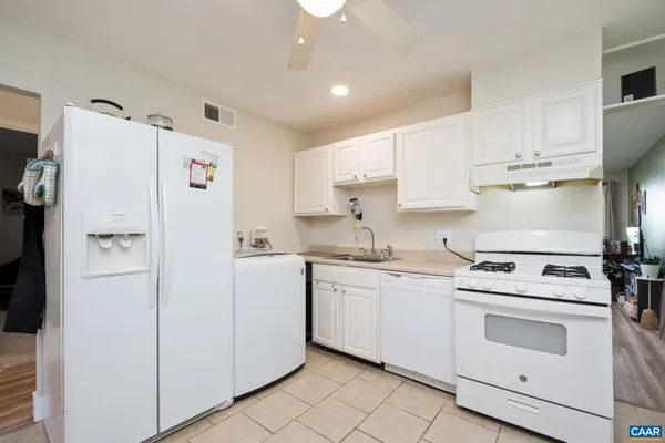 a kitchen with a white cabinets and white appliances