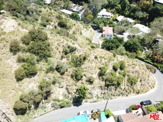 an aerial view of a house with a yard and garden