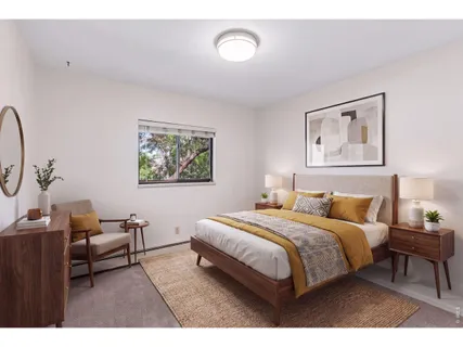 a bedroom with a bed and a painting on the wall