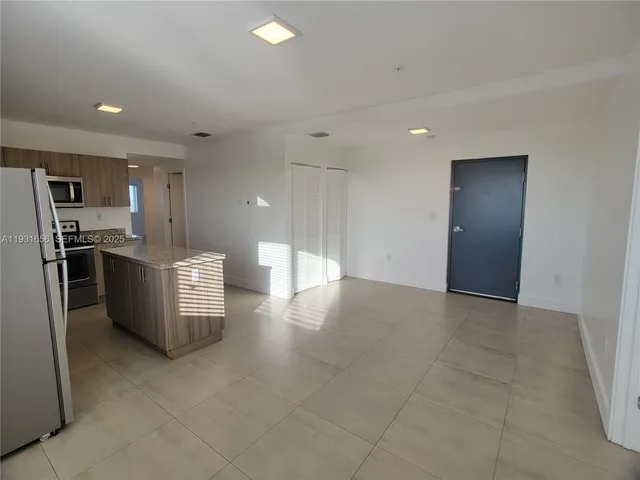 a kitchen with a refrigerator a stove top oven a sink and dishwasher