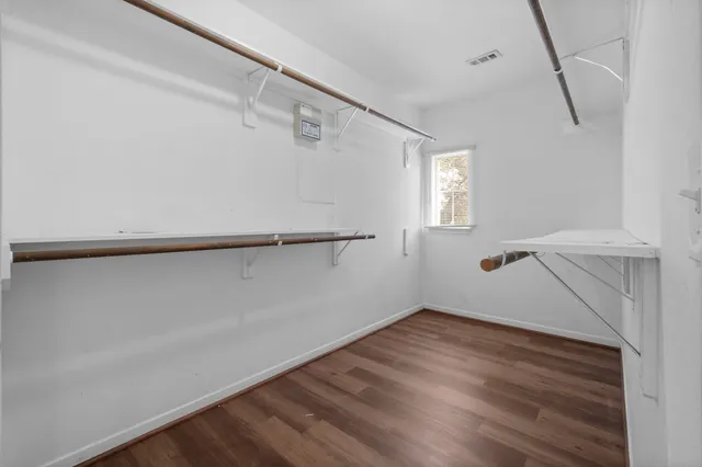 a view of a room with wooden floor and white walls