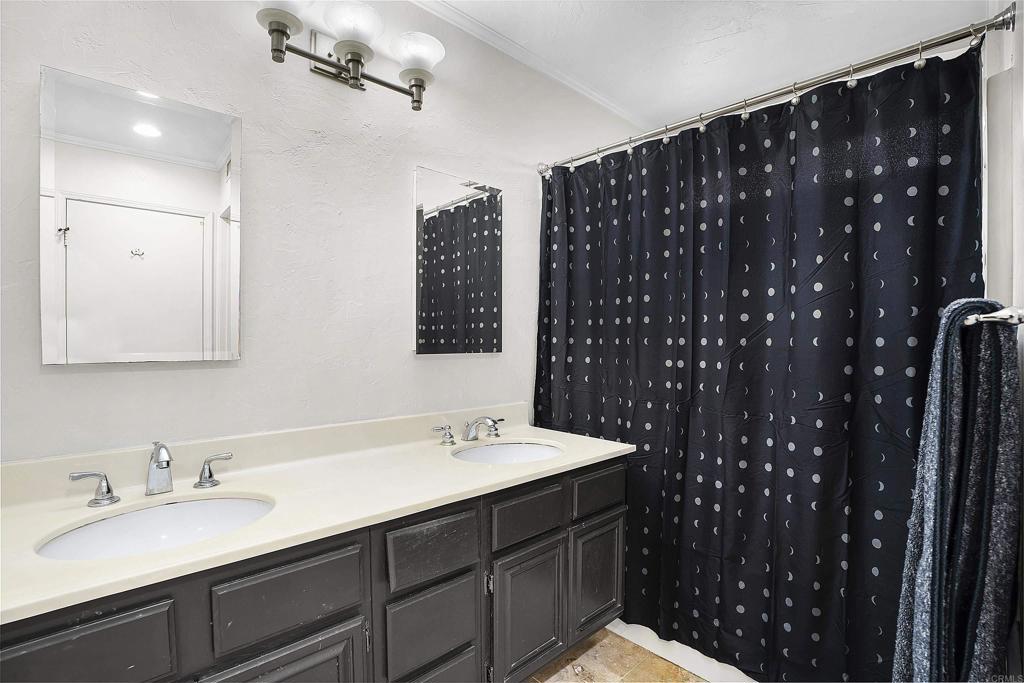 1826 Avenida Sevilla Oceanside, CA 92056 - Photo 11 of 34 a bathroom with double vanity sink and a mirror