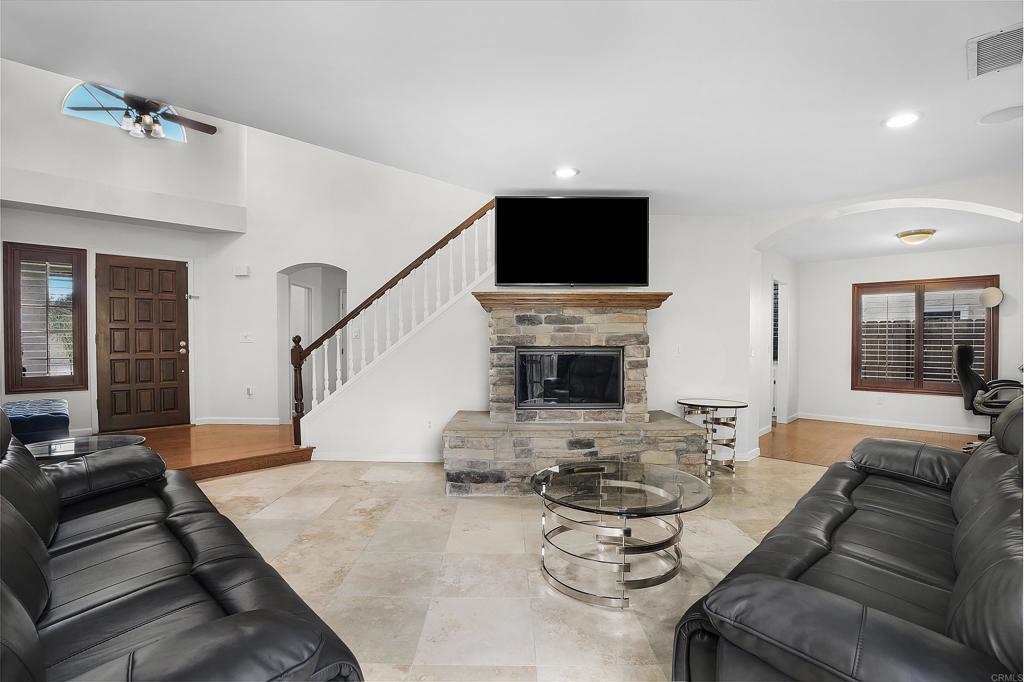 1826 Avenida Sevilla Oceanside, CA 92056 - Photo 14 of 34 a living room with furniture a fireplace and a flat screen tv