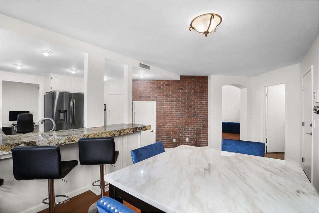 1826 Avenida Sevilla Oceanside, CA 92056 - Photo 17 of 34 a kitchen with stainless steel appliances kitchen island granite countertop a stove a sink and a dining table