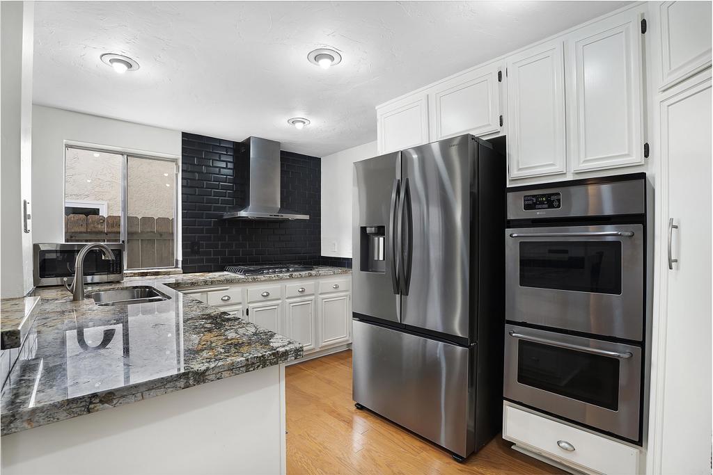 1826 Avenida Sevilla Oceanside, CA 92056 - Photo 19 of 34 a kitchen with stainless steel appliances a stove a refrigerator and a microwave