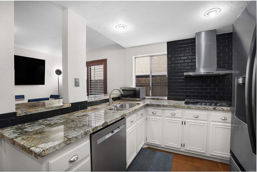 1826 Avenida Sevilla Oceanside, CA 92056 - Photo 20 of 34 a kitchen with granite countertop a sink and a stove