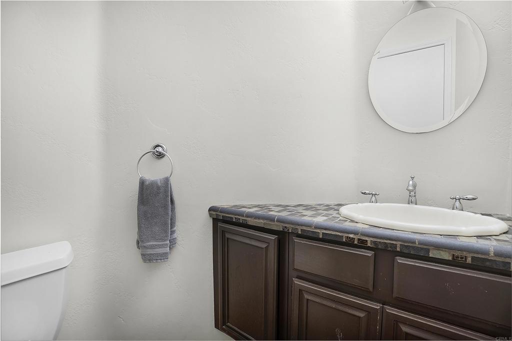 1826 Avenida Sevilla Oceanside, CA 92056 - Photo 21 of 34 a bathroom with a granite countertop sink and a mirror