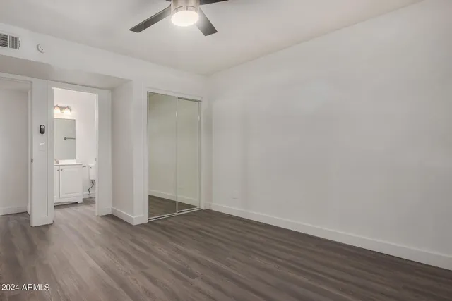 a bathroom with a sink toilet vanity and shower