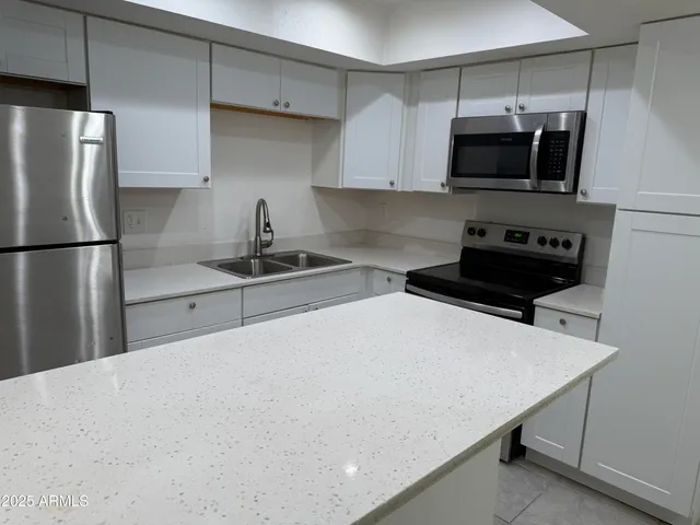 a view of a kitchen with a sink cabinets and a window