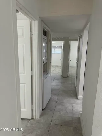 a utility room with wooden floor washer and dryer