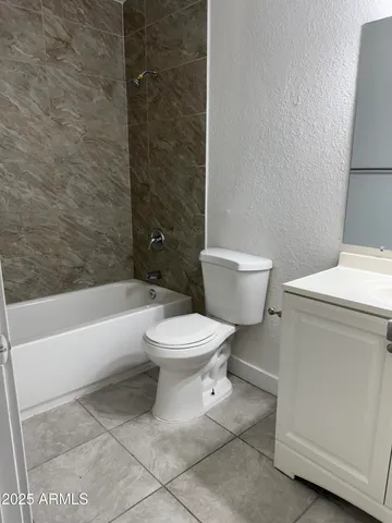 a view of a room with a ceiling fan and window