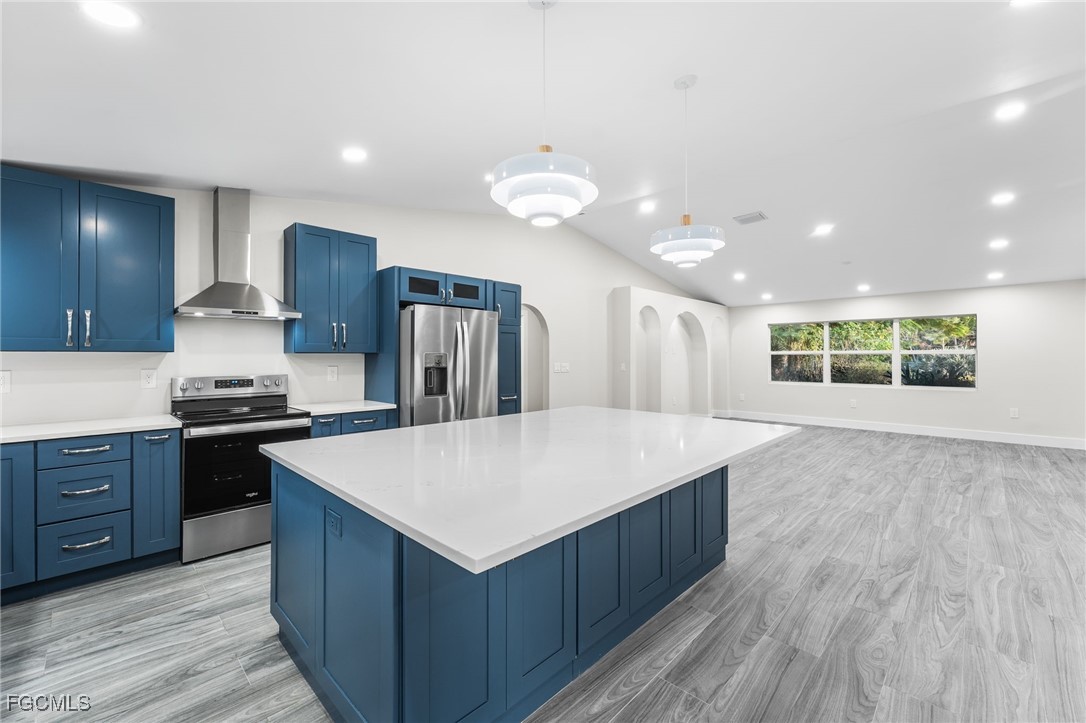 12860 Iona Road Fort Myers, FL 33908 - Photo 12 of 44 a large kitchen with stainless steel appliances granite countertop a large counter top a sink and a stove