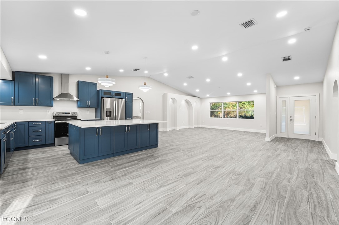 12860 Iona Road Fort Myers, FL 33908 - Photo 16 of 44 a view of kitchen with kitchen island stainless steel appliances wooden cabinets and window