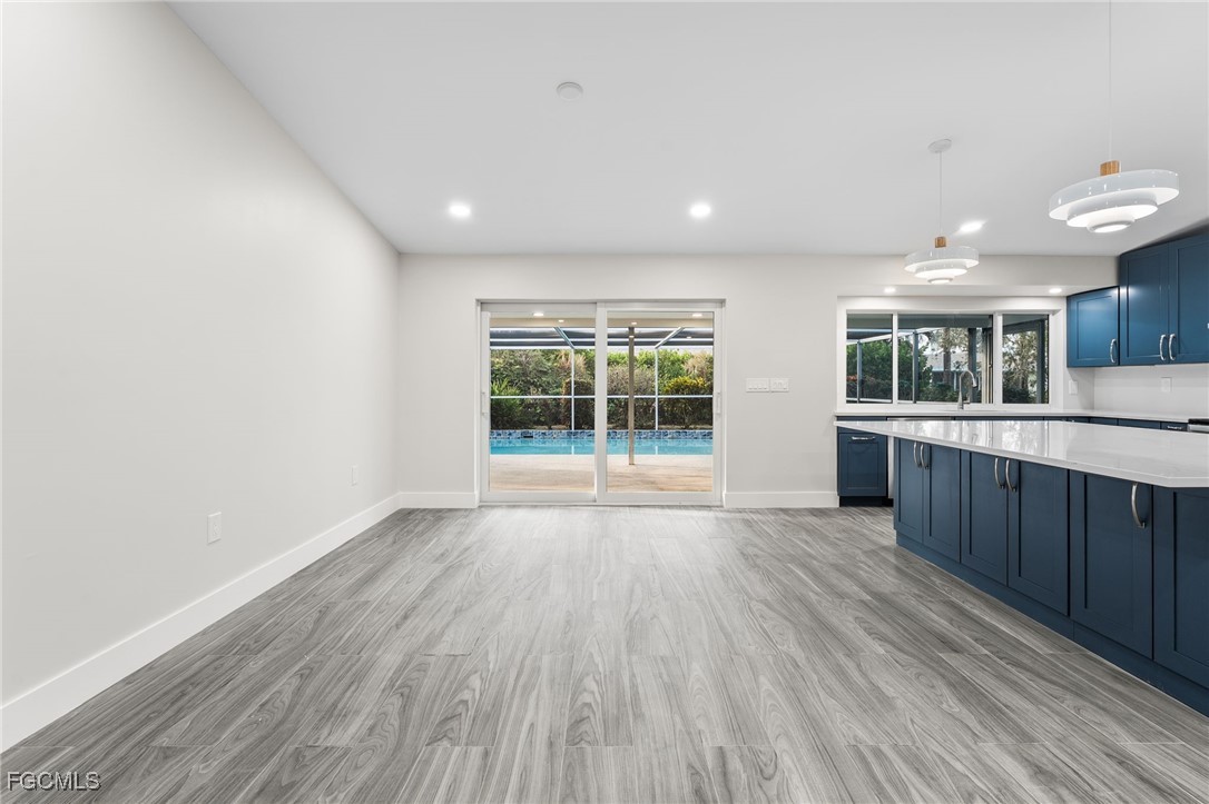 12860 Iona Road Fort Myers, FL 33908 - Photo 17 of 44 an empty room with wooden floor and windows