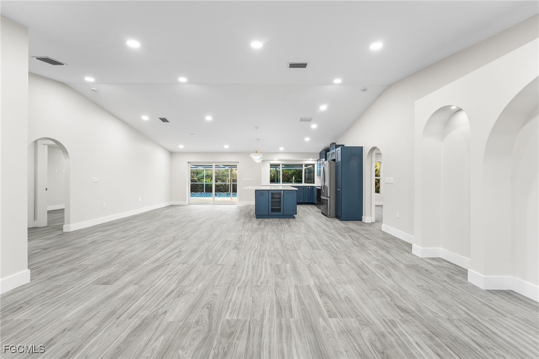 12860 Iona Road Fort Myers, FL 33908 - Photo 19 of 44 a big room with wooden floor and windows