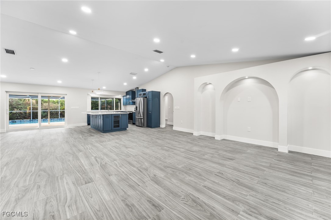 12860 Iona Road Fort Myers, FL 33908 - Photo 21 of 44 a view of empty room with wooden floor and window