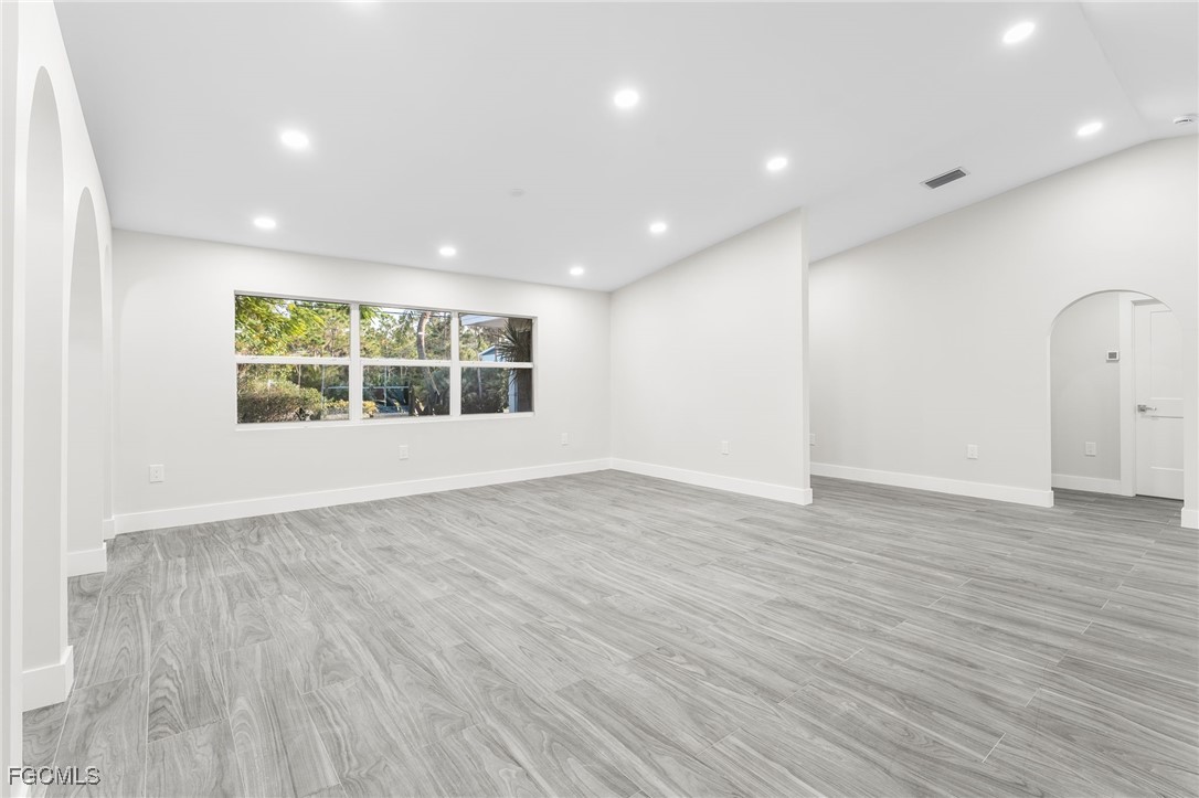 12860 Iona Road Fort Myers, FL 33908 - Photo 24 of 44 an empty room with wooden floor and windows