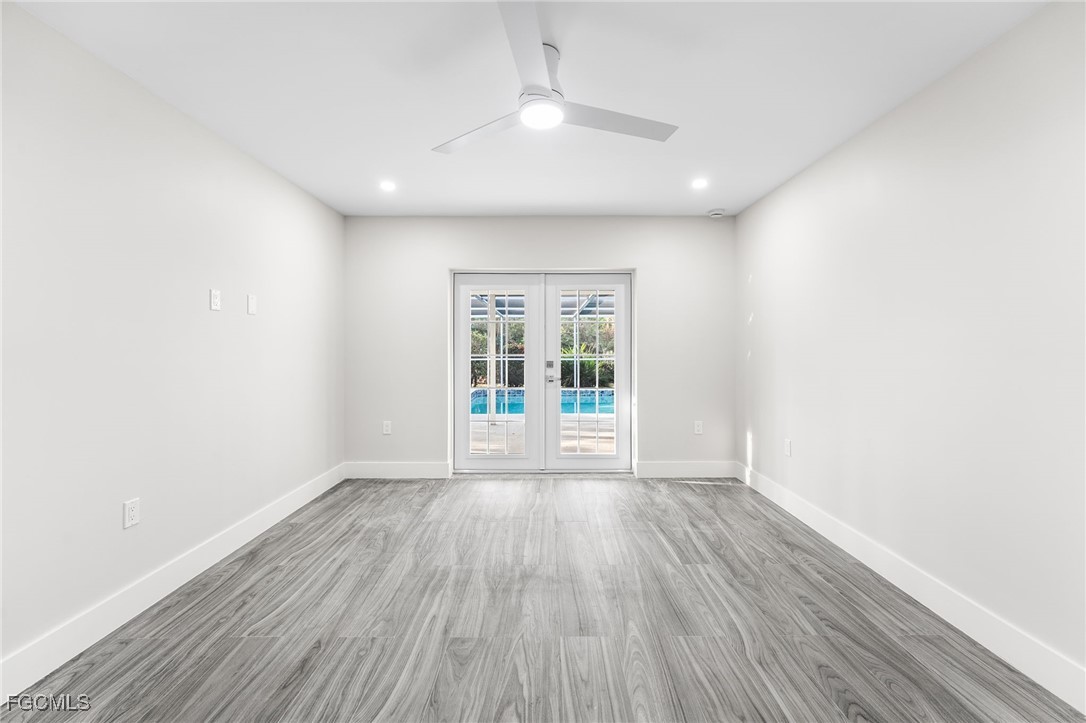 12860 Iona Road Fort Myers, FL 33908 - Photo 25 of 44 an empty room with wooden floor and windows