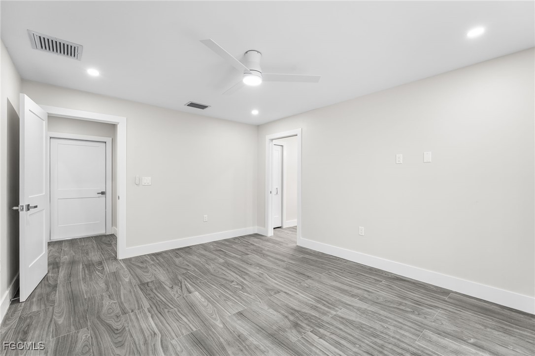 12860 Iona Road Fort Myers, FL 33908 - Photo 27 of 44 a view of an empty room with wooden floor