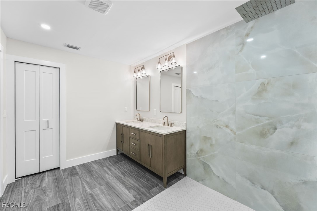 12860 Iona Road Fort Myers, FL 33908 - Photo 29 of 44 a bathroom with a sink and mirror