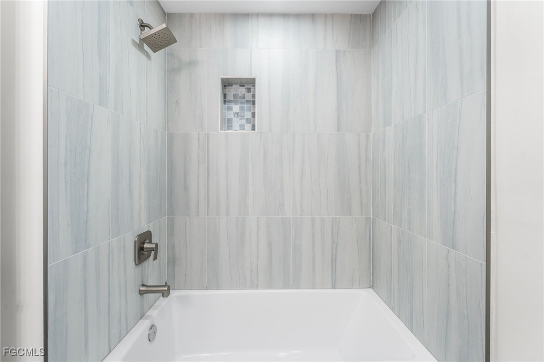 12860 Iona Road Fort Myers, FL 33908 - Photo 36 of 44 a bathroom with a bathtub and a shower
