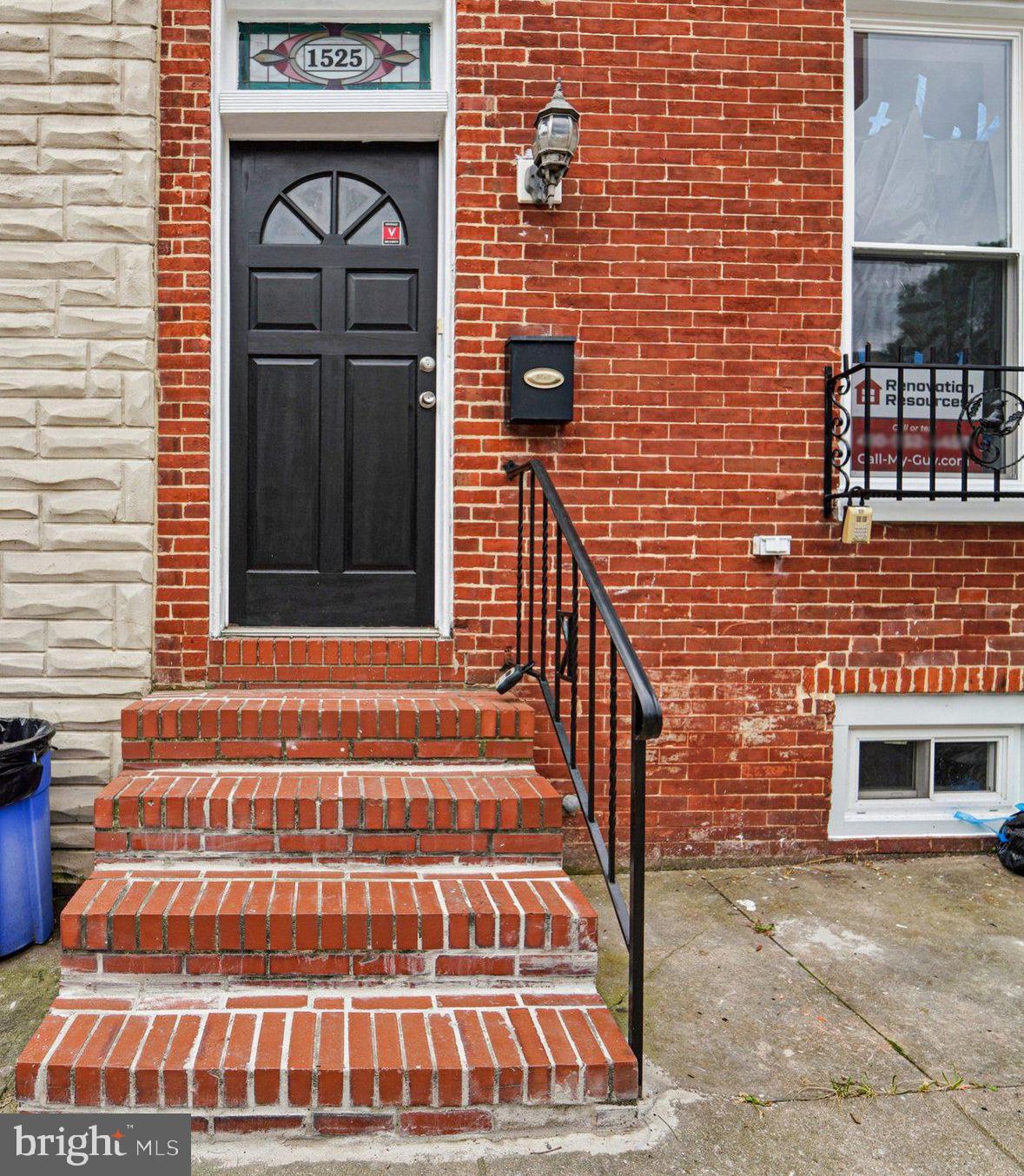 a view of front door of house with stairs
