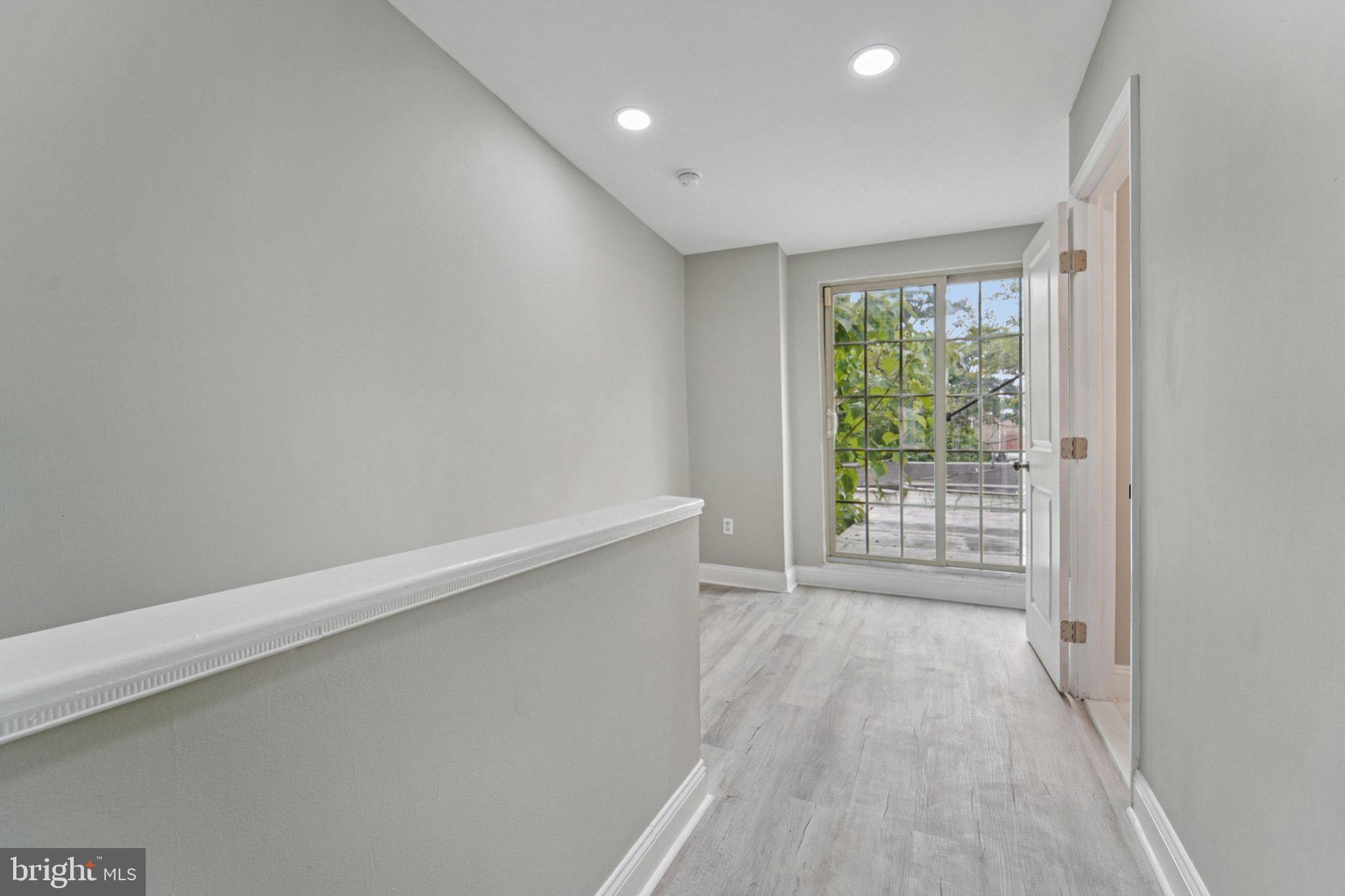 1525 West Pratt Street Baltimore, MD 21223 - Photo 17 of 31 a view of an empty room with wooden floor and a window