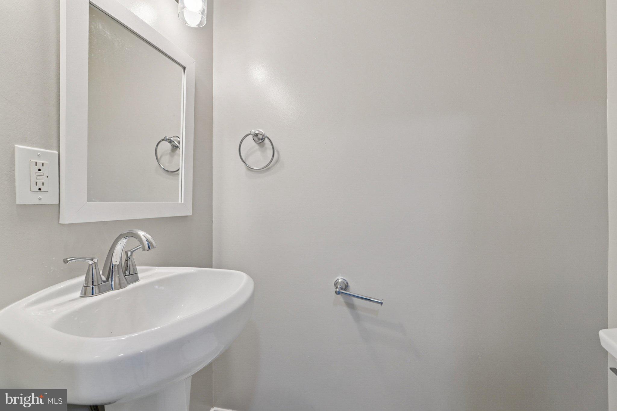 1525 West Pratt Street Baltimore, MD 21223 - Photo 26 of 31 a bathroom with a sink and mirror