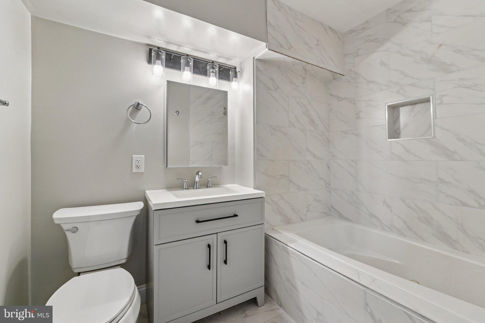 1525 West Pratt Street Baltimore, MD 21223 - Photo 10 of 31 a bathroom with a sink a toilet and shower