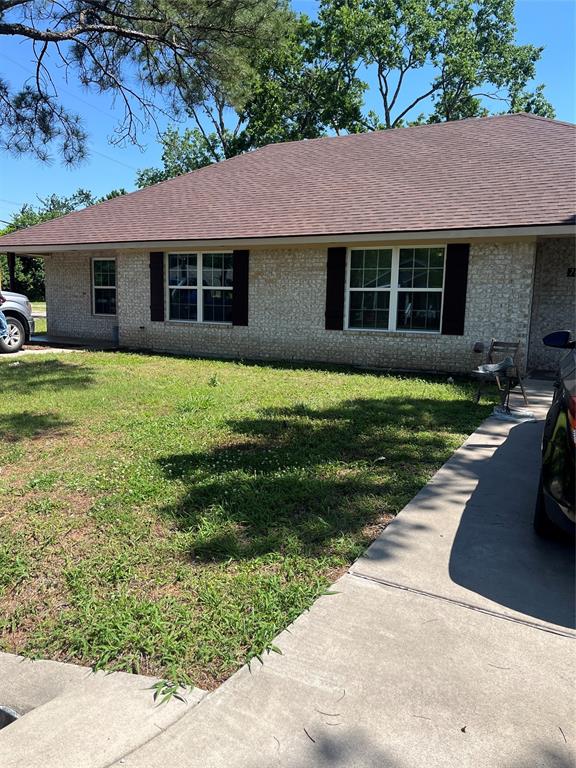712 Seven Oaks Road, Unit 712 Bonham, TX 75418 - Photo 14 of 14 a front view of a house with a garden