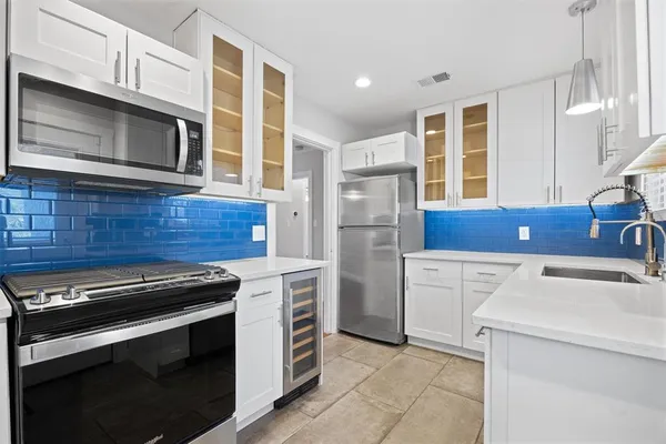 a kitchen with a stove microwave and refrigerator