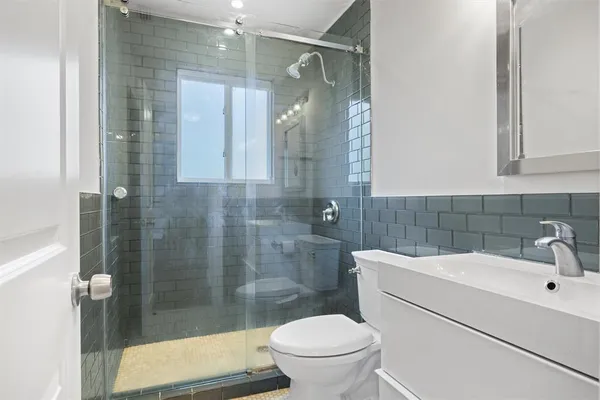 a bathroom with a sink toilet and shower