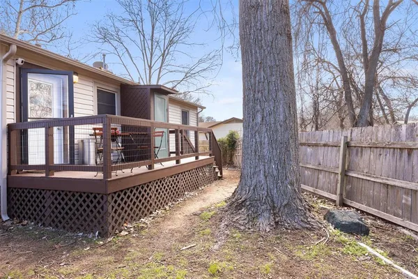 a view of house with a wooden fence