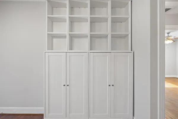 a view of a walk in closet with empty racks
