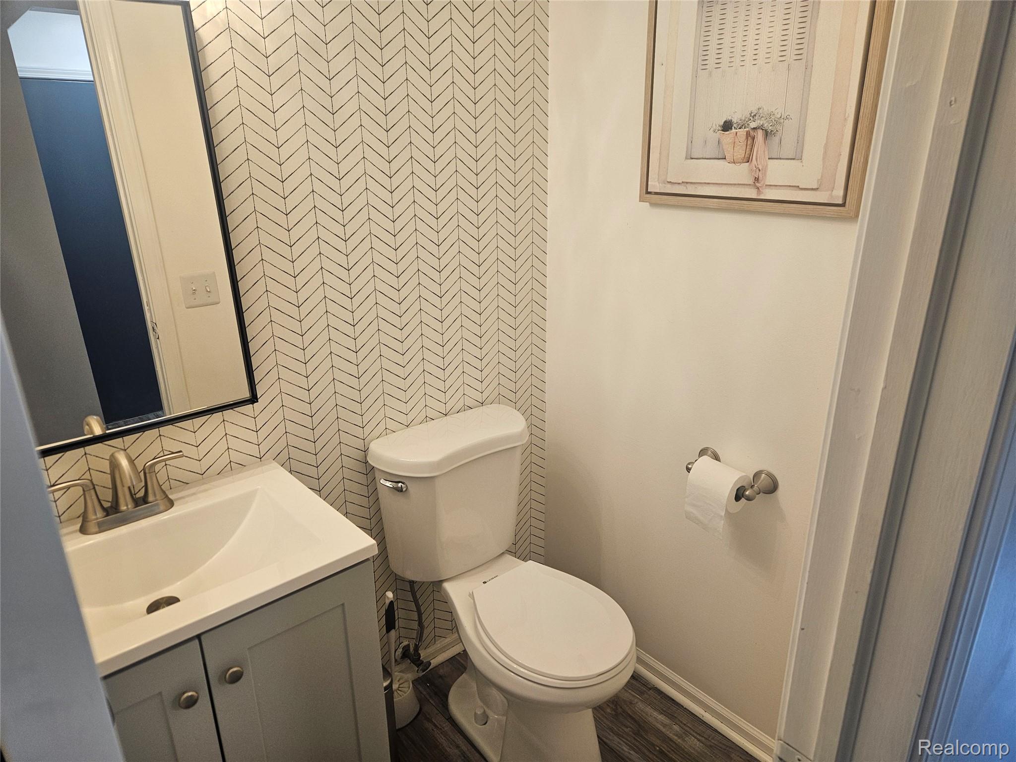 1210 Bay Ridge Drive Highland, MI 48356 - Photo 7 of 25 Half bath with vanity and wallpapered walls