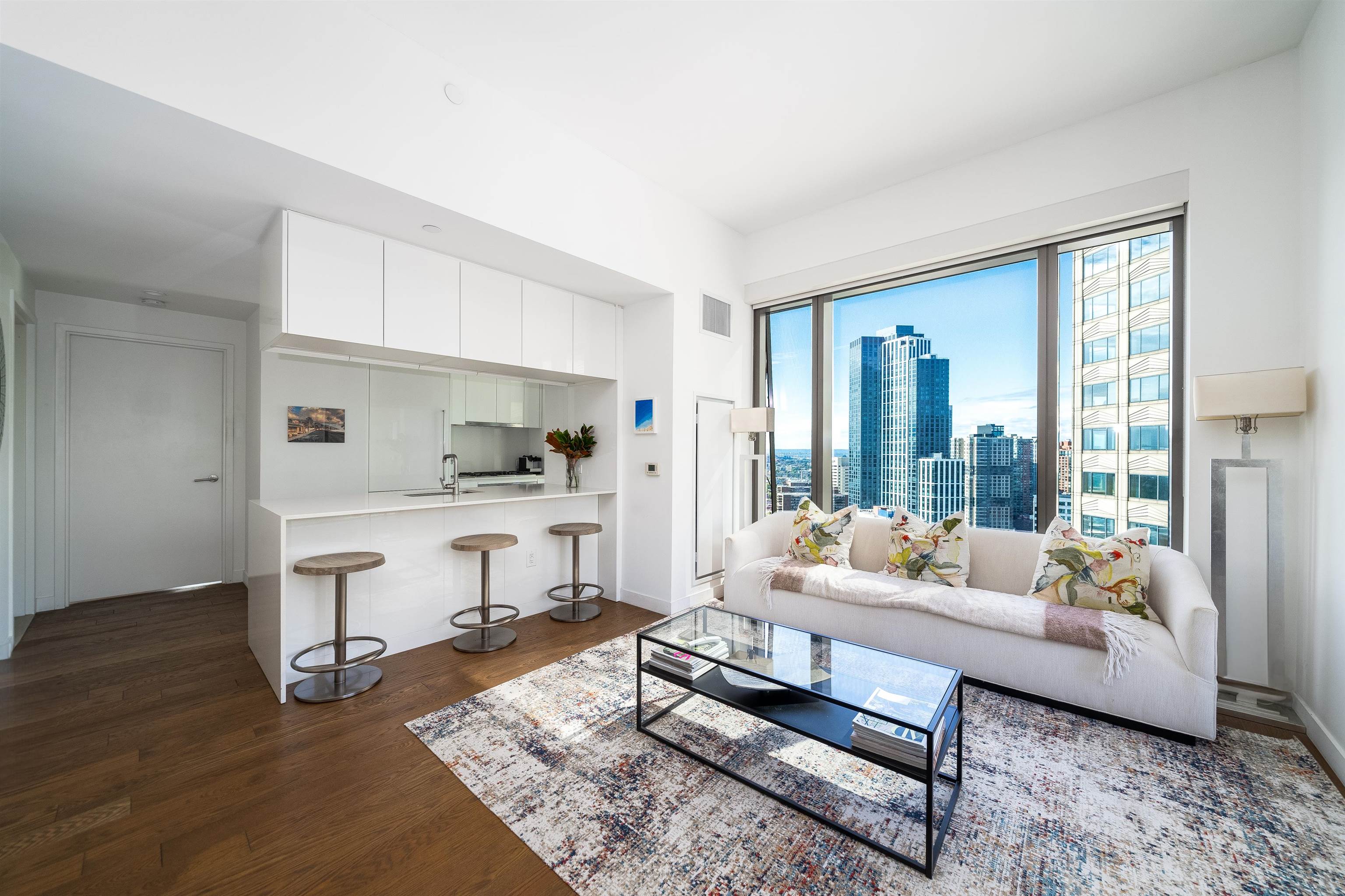 a living room with furniture and a table with wooden floor