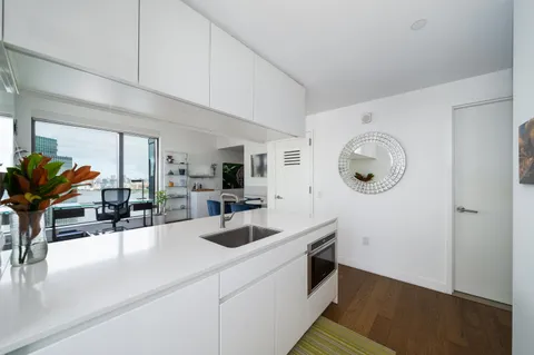 a kitchen with a sink a counter and cabinets