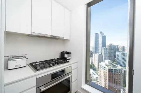 a kitchen with a stove and a white cabinet