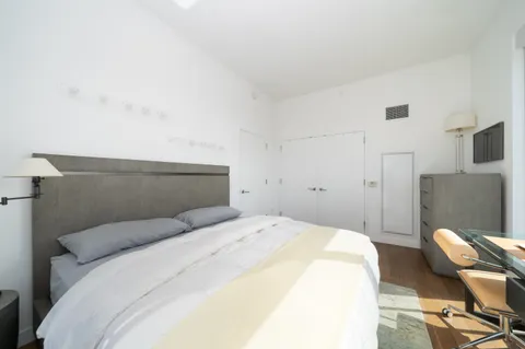 a bedroom with a bed and chair